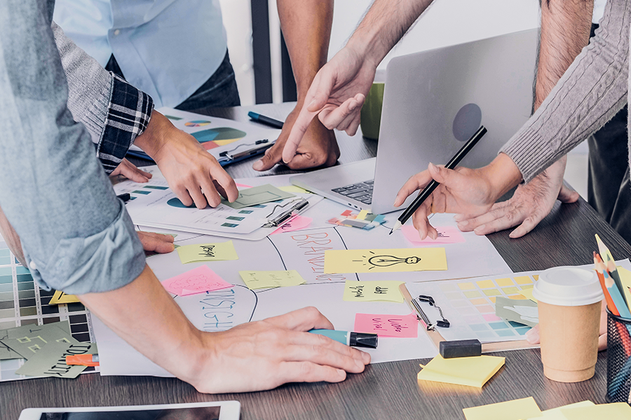 digital marketing consultation firm meeting at a table with papers on table for planning