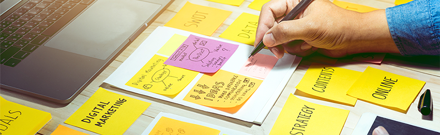 desk full of yellow sticky notes