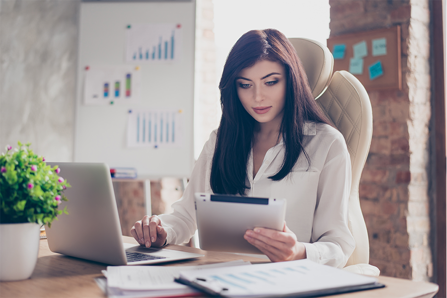 woman in office looking at ipad