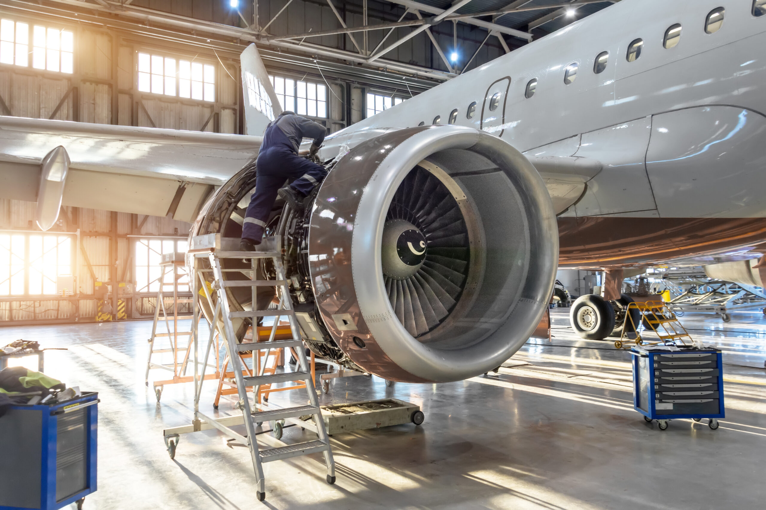 Mechanic specialist repairs the maintenance of engine of a passenger aircraft in a hangar geo services near akron ohio